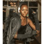 Fashion model posing confidently in stylish black outfit and accessories.