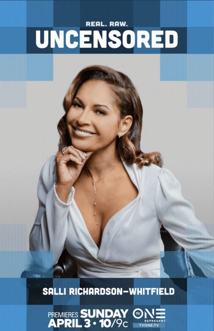Smiling woman in a white blouse posing confidently against a blue background.